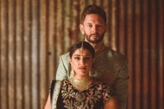 Couple in Indian wedding dress in the Really Rustic Barn